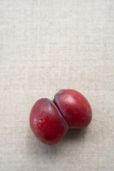 Ugly plums. Abnormal organic conjoined fruit in shape of butterfly