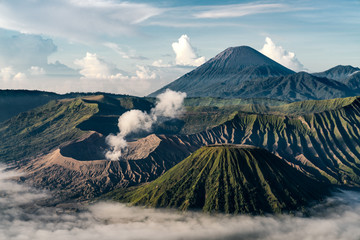 Beautiful view of Mount Bromo volcano during sunrise with white mist at Bromo tengger semeru national park, East Java, Indonesia © Sugrit