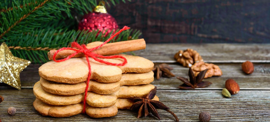 Christmas homemade gingerbread cookies and spices on the wooden background. Christmas mood. Happy New Year and Christmas. Holiday Postcard
