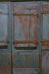 Old wooden door painted blue in the village of Labeaume in Ardeche, France.