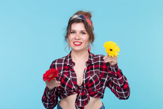 Summer, pin-up and fun concept - pretty woman with gerberas over the blue background