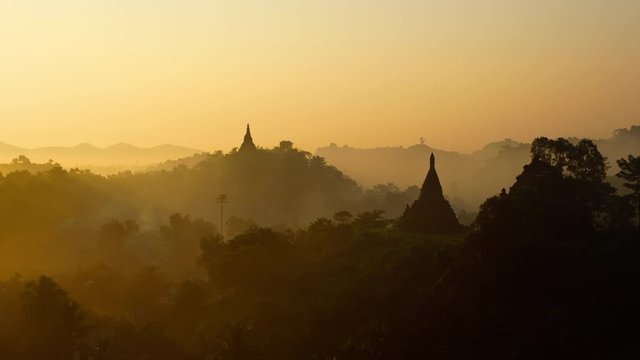 Time Lapse of morning fog and smoke moving past ancient temples in Myanmar