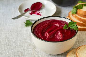 Thick beetroot cream soup in a gray bowl  
