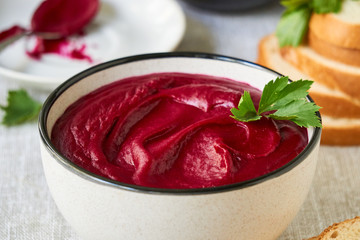 Thick beetroot cream soup in a gray bowl  