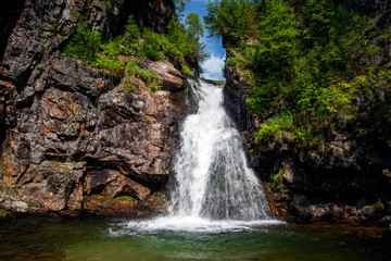 Waterfall. Mountain waterfall. Mountain river.