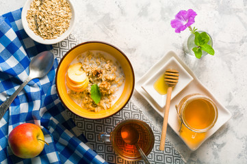 Morning oatmeal for breakfast. Early morning and healthy diet food. Proper nutrition. White stone background. Plenty of space for text.