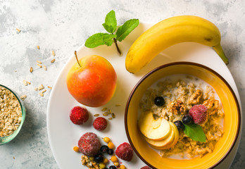 Morning oatmeal for breakfast. Early morning and healthy diet food. Proper nutrition. White stone background. Plenty of space for text.