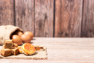 Traditional chinese cake or thai moon cake on wooden background, The words means happiness and fortune.