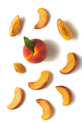 Fruit set. Ripe peach, peach slices, peach kernel on a white background
