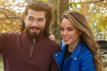 Couple in the park enjoying nice autumn time.