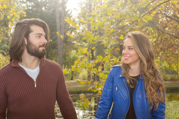 Couple in the park enjoying nice autumn time.