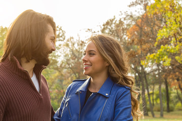 Couple in the park enjoying nice autumn time.