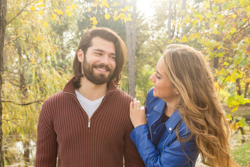 Couple in the park enjoying nice autumn time.