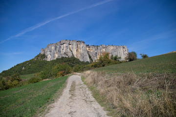 The stone of Bismantova, an isolated impressive spur in the italian appenines region. View from the rural path in the fields.