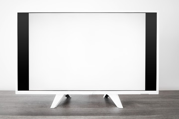 TV with white screen on a stand in the room.