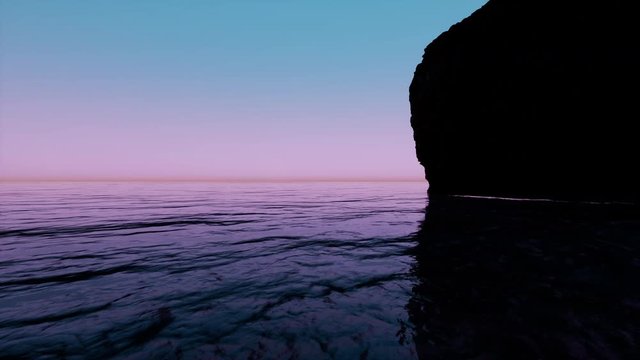 Sunrise and rock in the open sea