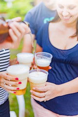 Friends enjoying drinking beer in the backyard.