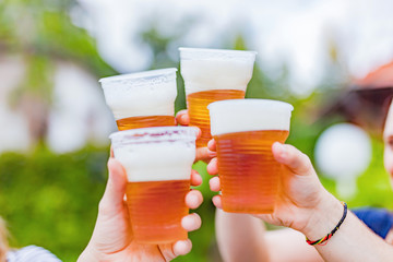 Friends enjoying drinking beer in the backyard.