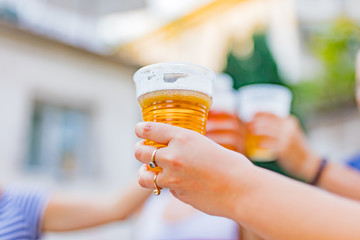 Friends enjoying drinking beer in the backyard.
