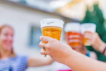 Friends enjoying drinking beer in the backyard.