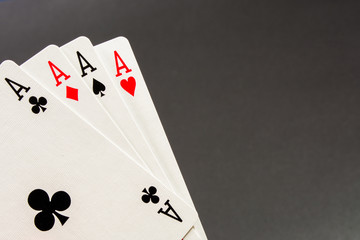 The combination of playing cards poker casino. Four aces on gray background