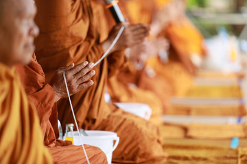 Thai religious rituals : hands of monks, Candles used in ceremonies and Offering