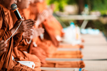 Thai religious rituals : hands of monks, Candles used in ceremonies and Offering