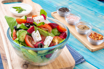 Mixed Vegetable Salads on Blue Wood Background - Mixed Gourmet Food , Mixed Healthy Food - Chicken Salad / Cheese Salad - Green leaves / Salad with Lettuce Leafs on Top and Cherry Tomatoes