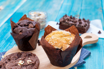 Chocolate Muffin and Vanilla Muffin with Brownie and Chocolate Cookie, Homemade Bakery on Blue...