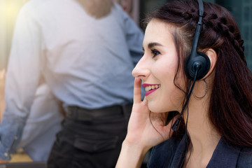 Caucasian woman with beautiful eyes wearing microphone headset working is telemarketing customer service agent in call center office with help care and support in a friendly service attitude.