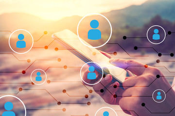 Man hand using smart phone on top of mountain with people icon and line dot abstract background. Copy space technology business and travel nature holiday concept.