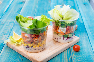 Mixed Vegetable Salads on Blue Wood Board - Mixed Gourmet Food , Mixed Healthy Food - Chicken Salad / Tuna Salad / Cheese Salad - Green leaves / Salad with Lettuce Leafs on Top
