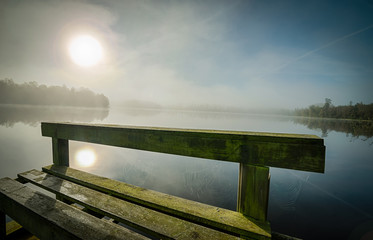 Wooden bridge and spider web at sunrise