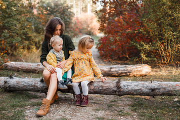 Beautiful young mother and her little daughter walking in summer park. Woman and cute kid girl spending time together. Happy family , sunny day