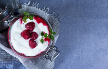 Healthy dietary delicious breakfast in jar on blue background. Close up. Healthy eating and self care concept.
