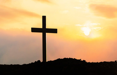 Silhouette cross on mountain at sunset background.Crucifixion Of Jesus Christ