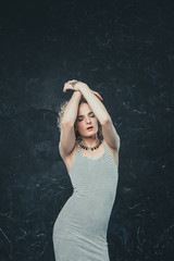 portrait a young man androgyne in the image of a woman in a dress stinging dress. with closed eyes...