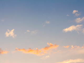 clear orange yellow sky background with blue clouds sunset or sunrise morning abstract texture.