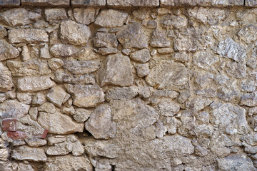 Ancient wall made of natural stones, old masonry as background