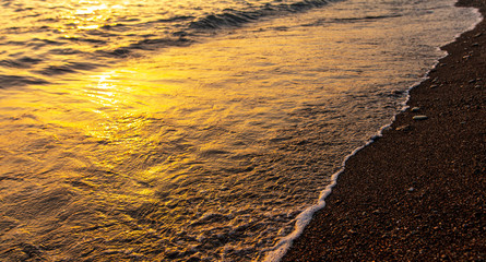 Waves on the seashore at sunset