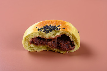 side view cut out red bean paste cake on a brown background