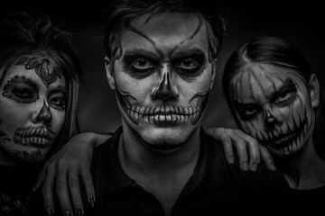 Male and female face art for Halloween. Black and white portrait of a guy and two girls with scary...