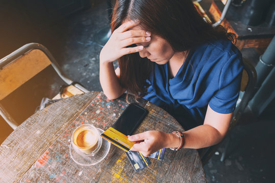 Closeup Image Of An Asian Woman Get Stressed And Broke While Holding Credit Card