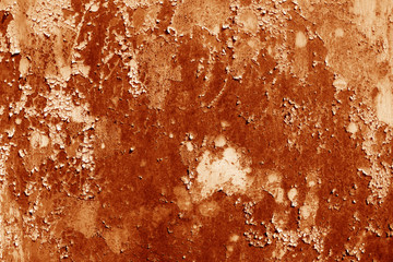 Grungy rusted metal wall surface in orange tone.