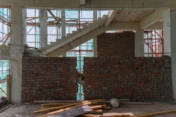 inside of an unfinished building with protection scaffolding and netting surrounded