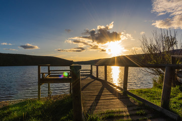 Views during the beautiful sunset on the dock for fishing of the Selga de Ordas reservoir in Leon, Spain