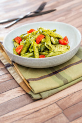 Pasta with pesto sauce and nuts on a the table