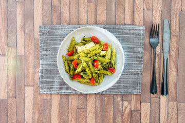 Pasta with pesto sauce and nuts on a the table