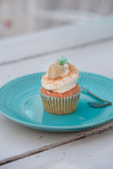 Tasty vanilla cupcakes on wooden board. Food on the nature