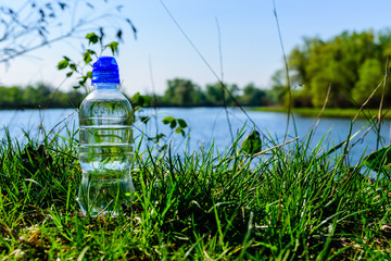 Plastic bottle with the clear water on wooden table